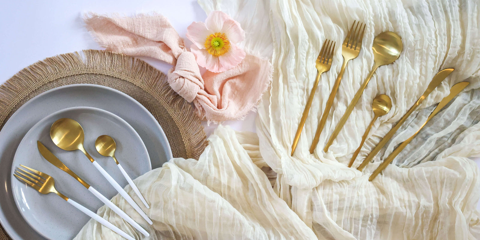 Flatlay of gold plated cutlery set on top of table runners