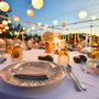 Table setting at a more casual wedding event by the beach