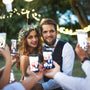 guests taking photos of the bride and groom on their smartphones