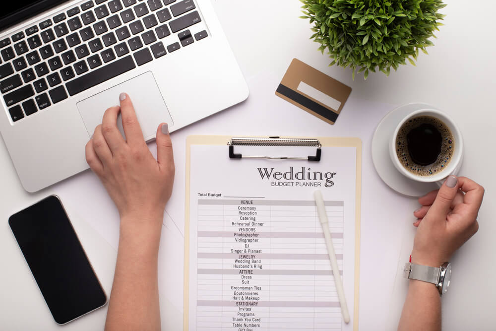 A woman planning a wedding with a limited budget with credit card on the table