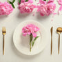 Feminine tablescape with pink peonies and gold cutlery
