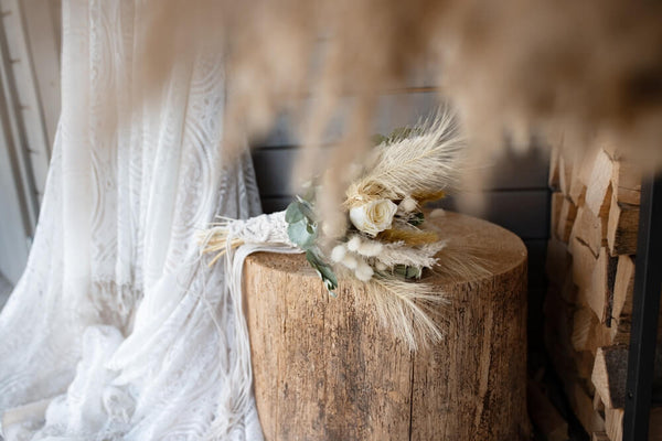 Rustic wedding decor as the backdrop of a dried bridal bouquet