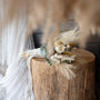 Rustic wedding decor as the backdrop of a dried bridal bouquet