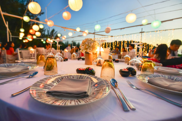Table setting at a more casual wedding event by the beach