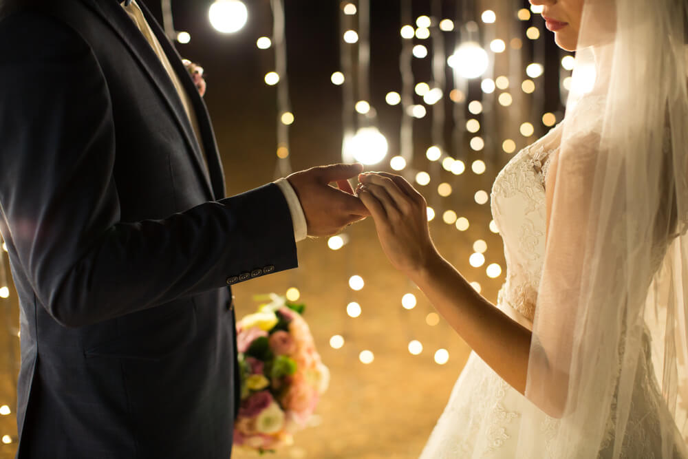 Couple getting married with beautiful lighting perfect for a rustic theme