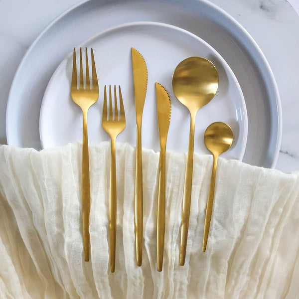 gold cutlery set on an elegant table setting