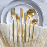 gold cutlery set on an elegant table setting